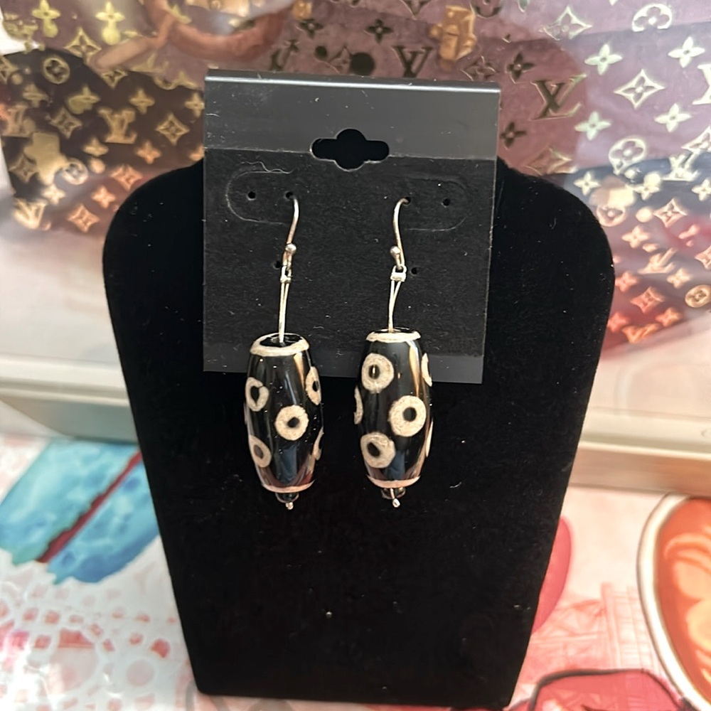 Ceramic. Black and tan cylinder shaped earrings. Lightweight